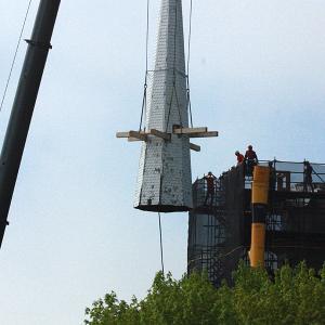 The spire atop the steeple at Chestnut Street Baptist Church in downtown Camden is cut free and lifted by crane Thursday morning. (Photo by Holly S. Edwards)