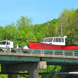 The ‘Hemingway’ comes over the Goose River Bridge for the June 10 launching. (Photo by Lynda Clancy)
