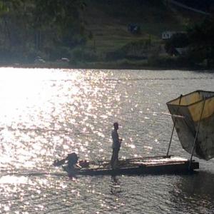 Bill Buchholz, in August 2016, works on cleaning the algae from Hosmer Pond. He obtained an old float from the harbor, and which had been bound for the tinder pile, outfitted it with the scooper, and spent the summer lifting the oxygen-starving algae from the pond. He hauled the green sludge up to his house, and composted it in the woods. (Photo by Lynda Clancy)