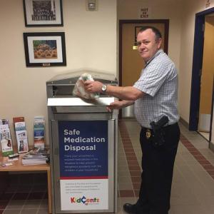 Detective Curt Andrick demonstrates the use of the new drug drop box at the Camden Police Department. (Photo courtesy of Camden Police Department)