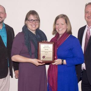 Kate Tagai and Karen Burns of the Island Institute (center, L-R) receive the 2017 Outstanding Program Award from current president Chris Marke (far right) and outgoing president Bryan Hains (far left) of the Community Development Society.