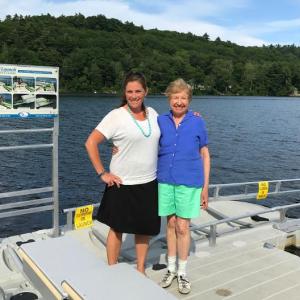 From left, Camden Parks and Recreation Director Beth Ward and Camden resident Elinor Klivans stand on the dock in front of the EZ Launch Accessible Transfer System Klivans donated to the town for public use.
