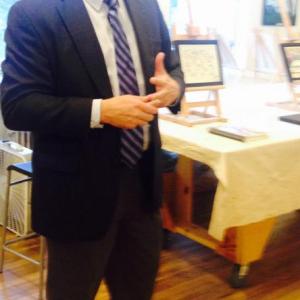 Maine State Prison Warden Randel Liberty speaks at the Art Loft show opening of art made by Maine State Prison inmates.