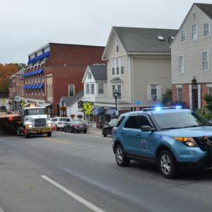 Brooklin Boat Yard transports a new 91-foot deck, constructed at Rockport Marine, in Rockport, over to Brooklin for finishing a new sloop. Escorted by the two state police vehicles, the convoy makes its way through downtown Camden early Sunday morning, Oct. 8. (Photo by Lynda Clancy)