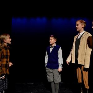 From left: Lucy (Grace Hayes) tells her siblings Edmund (Chris Hayes), Peter (Maci Burgess) and Susan (Erin Hayes) about Narnia. (Photo courtesy of Leah Bannister)