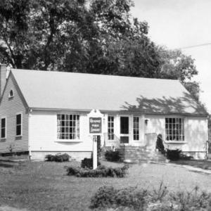 The Rockport Public Library, in its earlier days, on the the corner of Limerock Street and Russell Ave, in Rockport Village. The library site, which was deeded to the town in 1943, currently sits empty while the library collection sits in temporary quarters on Route 1, in Rockport. (Photo by Carroll Thayer Berry)