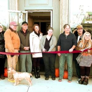 Kate McCoubrey (center) cuts the ribbon Friday, November 10, officially opening the Thomaston Cafe