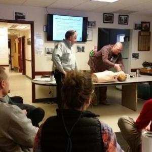 Justin Hills, paramedic and police officer, conducted the training on Jan. 17 for Camden and Rockport police and firefighters. In the photo, Hills is demonstrating how to administer Narcan on a practice dummy before Camden Fire Chief Chris Farley applies the proper technique. (Photo by Sarah Shepherd)