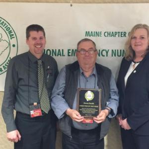 Outgoing NENA President Tammy Barker (left) and incoming president Brodie Hinkley (right) present Waldo County Communications Director Owen Smith with a plaque and certificate in 2016. (Photo by Mike Larrivee)