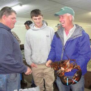 David Cousens, right, with two young Maine lobstermen. (Photo courtesy of MLA)