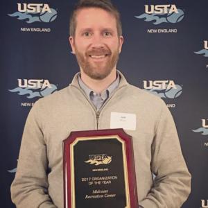 Seth Meyer accepts the USTA award at the New England USTA Conference.