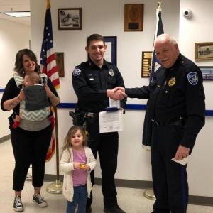 Rockland Police Chief Bruce Boucher presents a Meritorious Service Award to Officer Addison Cox for saving a man’s life who was injured during an assault. Cox’s family joined him for the presentation at the Rockland Police station. (Photo courtesy of the Rockland Police)
