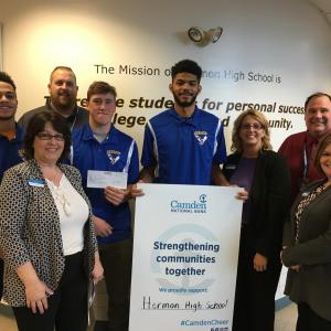 Denise Vera, Traci Tenney, and Amy Johnston of Camden National Bank present the donation to Hermon High School’s Athletic Director (Rick Sinclair), Principal (Brian Walsh), and three members of the boys’ basketball team.