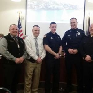 Camden Fire Chief Chris Farley, Police Chief Randy Gagne, Detective Curt Andrick, Firefighter Isaiah Backiel, Officer Chris Hansen, recently hired Officer Paul Thompson and Sgt. Dan Brown gathered after the presentations of their life saving awards and commendations at the Camden Select Board meeting March 5. (Photo by Sarah Shepherd)