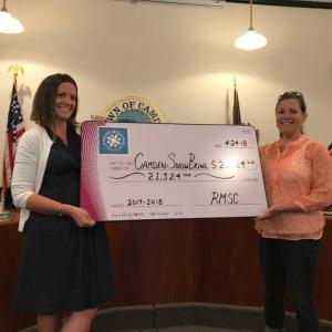 RMSC President Wendy Zwecker delivers a check to Beth Ward, Snow Bowl manager, at the April 24 Camden Select Board meeting.