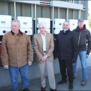 Dick Sampson, Jim Polky, Richard Bates, Jerry Hall, Ken Oelberger, Madeline MacCaffray and Maggie Gill throw the switches to turn on the solar power system.
