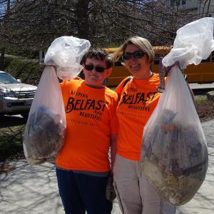 Martha Conway-Cole stands beside a student with some of the trash they picked up. (photo by Erica Thoms)