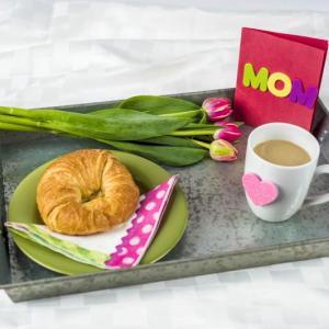 Breakfast in bed is only one of many ideas for a creative Mother’s Day. (Photo by Metro Creative)