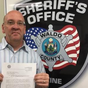 Chief Deputy Jason Trundy poses with his acceptance letter. (Photo courtesy of the Waldo County Sheriff’s Office)