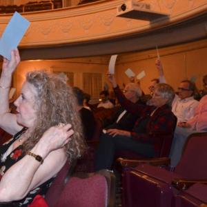 Camden citizens raise their hands in opposition to divesting approximately 200 feet of an old Arey Road easement June 13 at the annual 2018 Town Meeting.