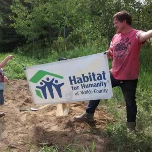 Future homeowner Michael Curtis poses at the site of his new home with his son, Camden, at the July 31 groundbreaking, which was a private event. (photo courtesy of Habitat for Humanity of Waldo County)
