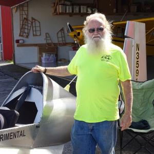 Robert Dodge poses with his homemade aircraft. (photo by Erica Thoms)