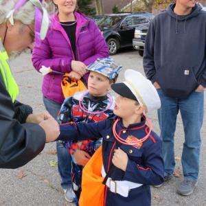 Jeff Sukeforth, Post Adjunct of the American Legion in Camden, distributed free glow in the dark necklaces in 2017 to help keep trick-or-treaters safe on Pearl Street. (Photo by Norm Carver)