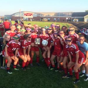 The Camden Hills girls soccer team celebrates Kristina Kelly’s 100th career goal. (Courtesy Steve Alex)