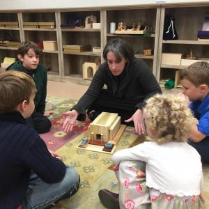 Elizabeth Lally and the children explore the hands-on resources of the Godly Play curriculum. (Photo courtesy of The First Congregational Church of Camden)