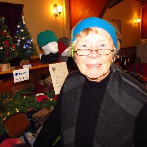 Mary Alice Bird in one of her head warmer designs at the Festival of Lights Craft Fair in Rockland. (Photo by Kay Stephens)