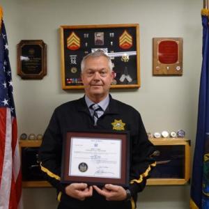 Trafton poses with his 2015 certificate from Governor LePage certifying the votes electing him. (photo by Erica Thoms)
