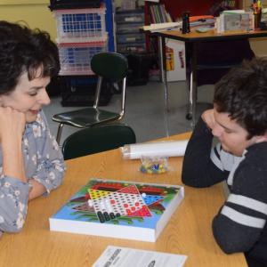 Grade 3 teacher, Rose Richter and Owen deLorimier play Chinese Checkers as during a stay-cation trip around the world. (Photo courtesy Thomaston Grammar School)