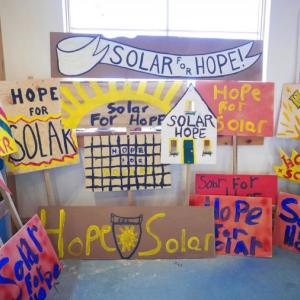 An array of signs promoting a switch to solar energy in Hope’s municipal buildings. Photo by Lindsay Pinchbeck. hope, maine, solar, energy, power, vote