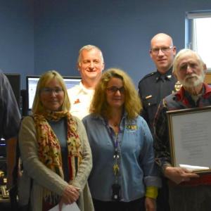 The front lines, background coordination, and business side come together to recognize Knox County dispatchers. L to R: Dispatcher Timothy McLaughlin, County Commissioner Sharyn L. Pohlman, Camden Fire Chief Chris Farley, Dispatch supervisor Stephanie Gibbs, Rockland Police Chief Chris Young, and County Commissioner Richard L. Parent, Jr.