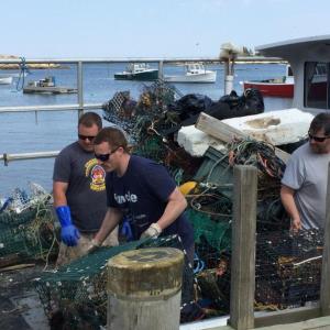 Loading Matinicus lobsterman Jarod Bray’s boat “Volition.” Left to right: lobsterman Derek Webber, Jarod Bray, lobsterman Sam Rogers. (Photo courtesy Eva Murray)