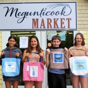 Seventh-grade students from Camden-Rockport Middle School line up in front of Megunticook Market to show off their work. (Photo by Ellen Curtis)