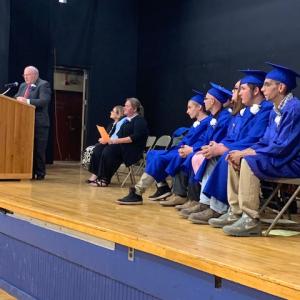 Speakers take the stage during a graduation ceremony. (Photo courtesy Belfast Adult Ed)