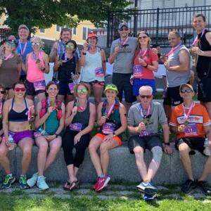 Two Midcoast teams, plus a few more runners from the Midcoast, pose for a photo at the finish line. (Photo courtesy Trail Runners of Midcoast Maine)