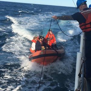 Coast Guard Cutter Ocracoke's small boat crew returns to the cutter after rescuing two boaters off the coast of Maine, Sunday, Aug. 11, 2019, near Cashes Ledge. The wife of one of the boaters reported her husband missing to Coast Guard Sector Northern New England the previous night. (U.S. Coast Guard photo by Seaman Michael Neo)
