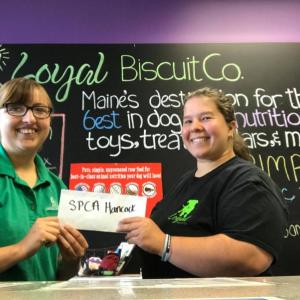 Danielle Bauer from the SPCA of Hancock county receives Fenway Fund grant money from Shawna Harriman, Loyal Biscuit Co. representative for the Fenway Fund Committee. (Photo courtesy Loyal Biscuit)