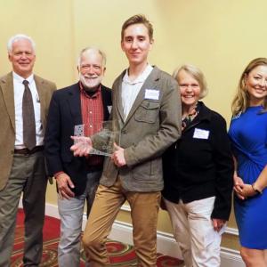 Pictured L-R with Unsung Hero, Linford Young, center, are John Viehman, Courier Publications; Ray Estabrook, Game Loft; Patricia Estabrook, Game Loft; and Megan Williams, UMC Executive Director. (Photo by Marti Stone)