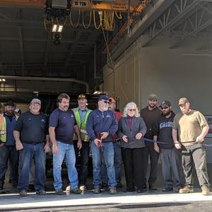Ribbon cutting in front of the new public works facility: Jody Seekins Jr., Jay Hassepelis, Kip Faulkner, Scott Sawyer, Bob Richards, Alan Armstrong, Mary Mortier, Brian Richter, Steve Warman, Brandon Peasley. (Photo courtesy Ledgewood Construction)
