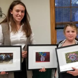 Aldermere Achievers 4-H members, Elizabeth Eaton and Isabelle Baker, hold their photos from the Knox-Lincoln 4-H Photography Contest. (Photo by Heidi Baker)