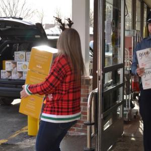 Filling the cruiser, box by box — 590 total — and many trips back and forth to the Camden Area Food Pantry. Mariah Singer and Candie Martin, Hannaford employees; Rockport Police Officer Tony Del Vecchio; Camden Police Officer Mark Bennett; and Camden Hannaford Store Manager Bob Josselyn. (Photo by Lynda Clancy)
