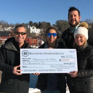 Matthew Levin, director of Hotels and Marketing; Erick Anderson, general manager; and Allyson Poutasse, director of Rooms present Rockport Harbor Master Abbie Leonard with a $1,000 check for the Dec. 21 Holiday on the Harbor celebration in Rockport.