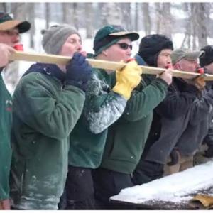 A sip from the ‘Stupid Stick’ is an invention of the Throbbin Boggins toboggan racing team and shared by their friends and rivals, Big Kahoonas. Photo courtesy Holly Anderson.