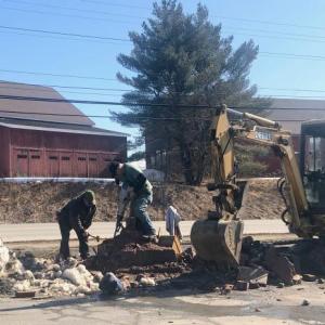 Bruce Colson and his crew work to remove the old “Helm” signpost along Route 1 in Rockport on Feb. 24. (Photo: Lynda Clancy)