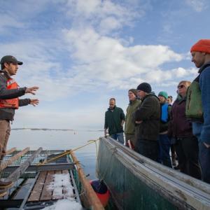 Matt Moretti (left) from Bangs Island Mussels takes ABD participants on a tour of his farm operations during the group’s annual Industry Day event in December. (Photo courtesy Island Institute)