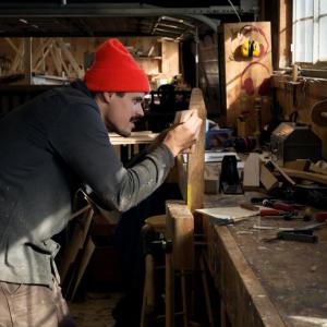 Chris Battaglia, another recent 12-week apprentice, works on the complex joint where the chines of the boat come into the bottom of the stem. The techniques he is learning in the context of this difficult task – problem solving, 3-D visualization, persistence in the face of challenge – are not just specific to boatbuilding. They apply to all different kinds of pursuits. (Photo by Erin Tokarz)