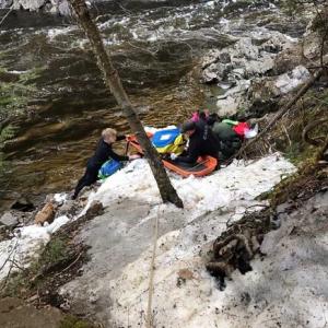 Maine Game Wardens and emergency rescue personnel attend to an injured Antonio Jacobs alongside Moxie Stream as they prepare to extract him out of Moxie Gorge. (Photo courtesy Maine Warden Service)